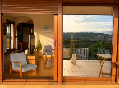 View from the living room onto the terrace and surrounding landscape. - image 9