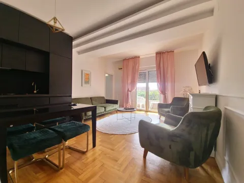 Living room with sofa set, dining table, and kitchen units. - image 10