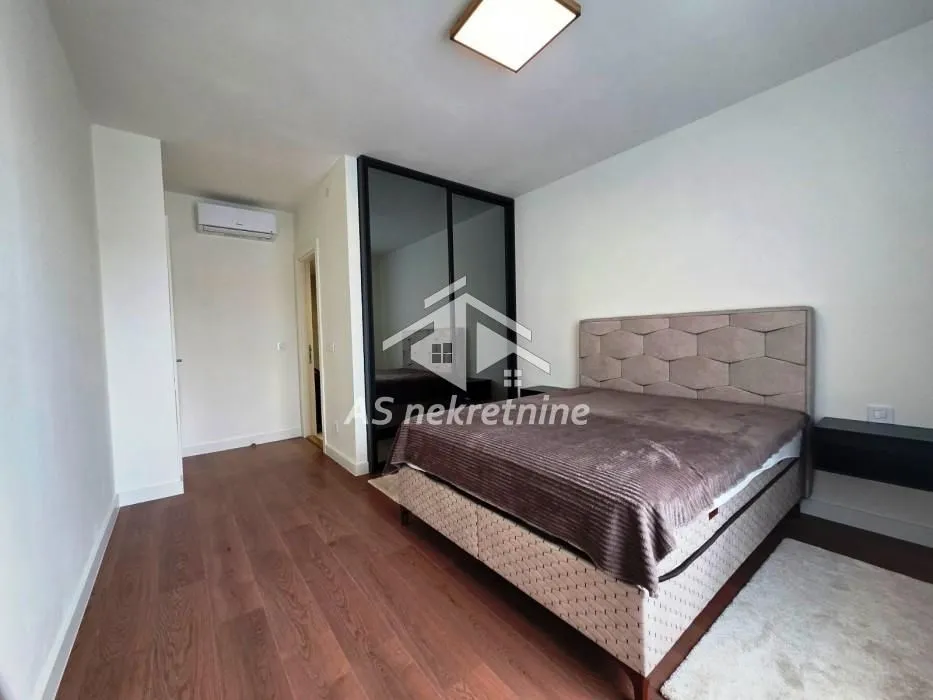 Bedroom with a double bed and a mirrored built-in wardrobe.