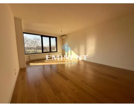 Empty living room with hardwood floors and a large window. - image 2