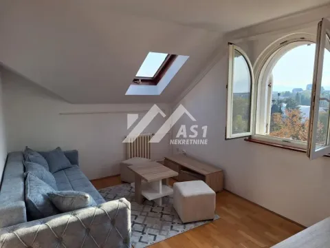 Attic living room with sofa, skylight and view through an arched window. - image 9