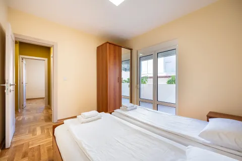 Furnished bedroom with two single beds and terrace access. - image 8