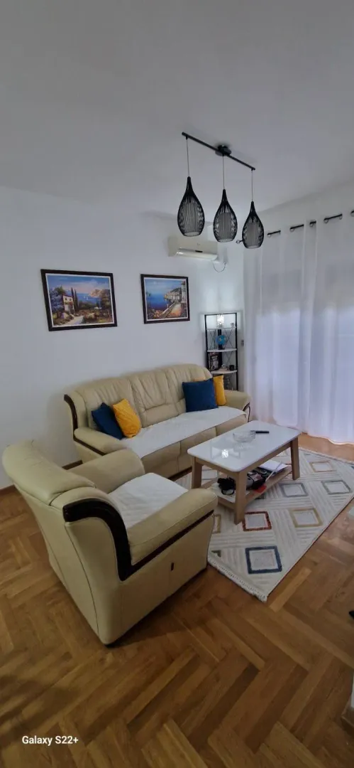 Furnished living room with seating set and coffee table.