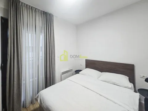 Bedroom with a double bed and a window with curtains. - image 7