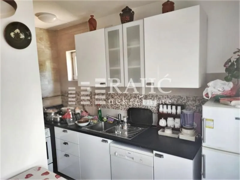 Small kitchen with white cabinets and a countertop.