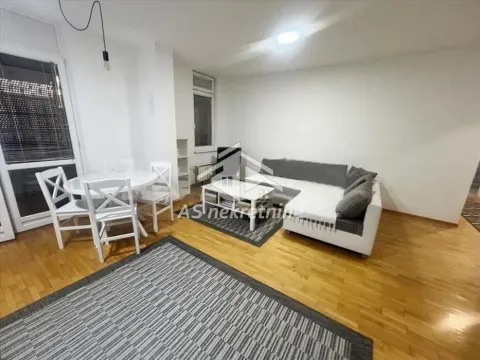 Living room with a sofa set, dining table and hardwood flooring. - image 3