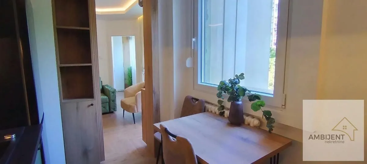 View from the kitchen towards the living room with a dining table.
