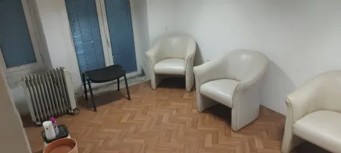 Empty room with parquet flooring and several armchairs. - image 7