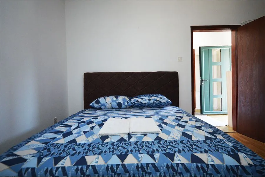 Bedroom with a double bed and blue bedding.