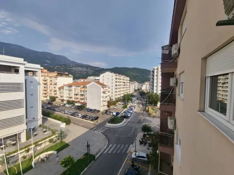 View from the window overlooking surrounding buildings and street. - image 6