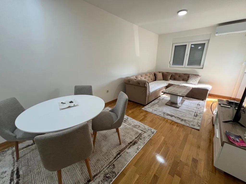 Living room with a sofa set and a dining table.