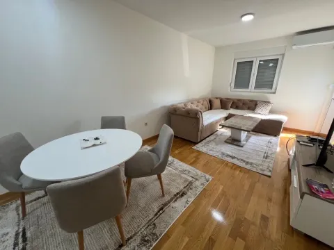 Living room with a sofa set and a dining table. - image 2