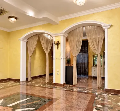 Spacious living room with arched doorways and marble flooring. - image 5