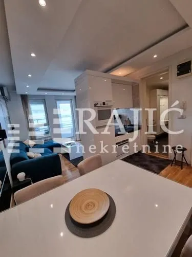 Modern living room interior with a dining area and kitchen.