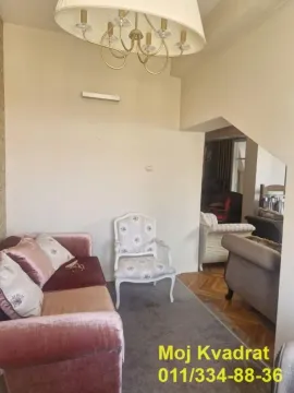 Living room with a sofa and armchair. - image 4