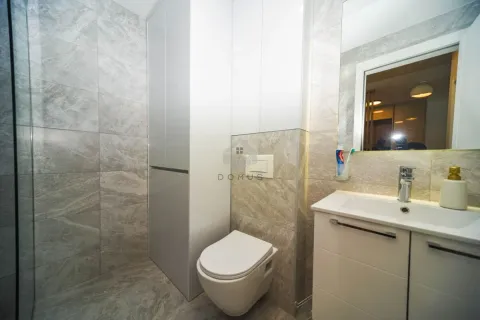 Modernly equipped bathroom with a shower cabin, washbasin, and built-in units. - image 9