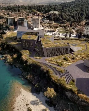Pogled iz vazduha na moderni kompleks zgrada sa uređenim krovnim vrtovima pored obale mora. - image 10