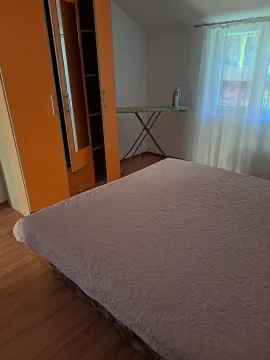 Bedroom with a double bed, wardrobe, and ironing board. - image 6
