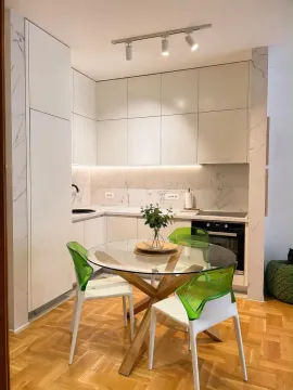 Modern kitchen with a dining table and glass chairs. - image 5