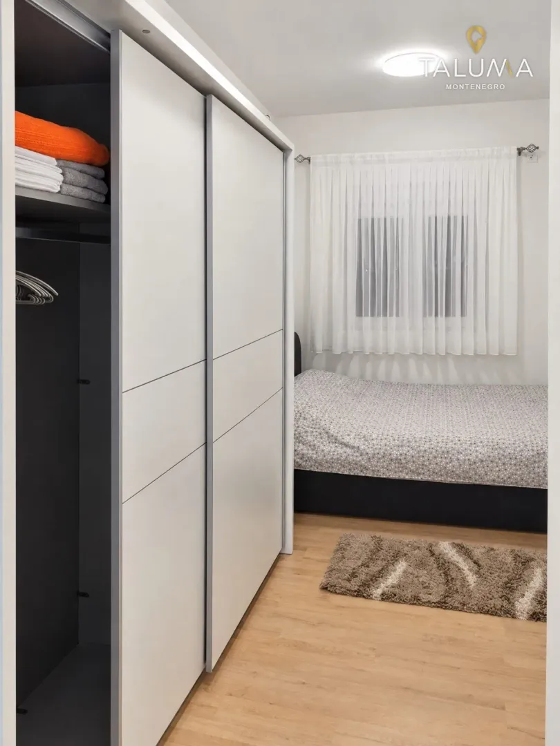 Bedroom with a large built-in wardrobe and a bed.