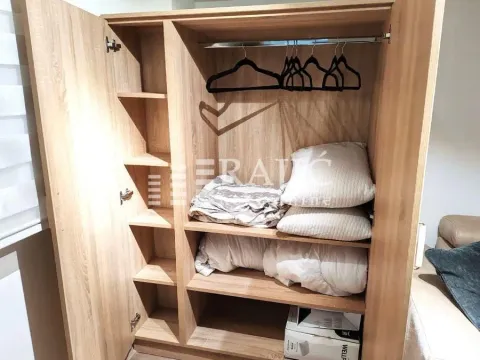 Wooden wardrobe with shelving and hanging space. - image 5