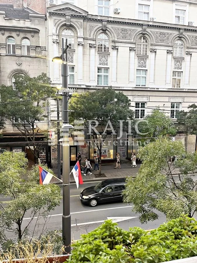 View from the terrace of the street and the old building facade across.