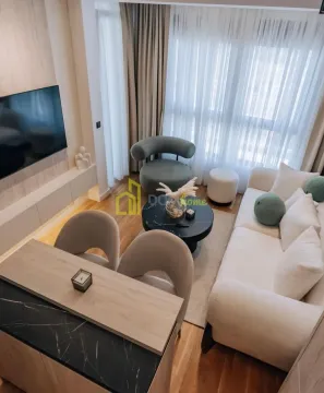 Living room with a sofa, TV, and dining table. - image 9