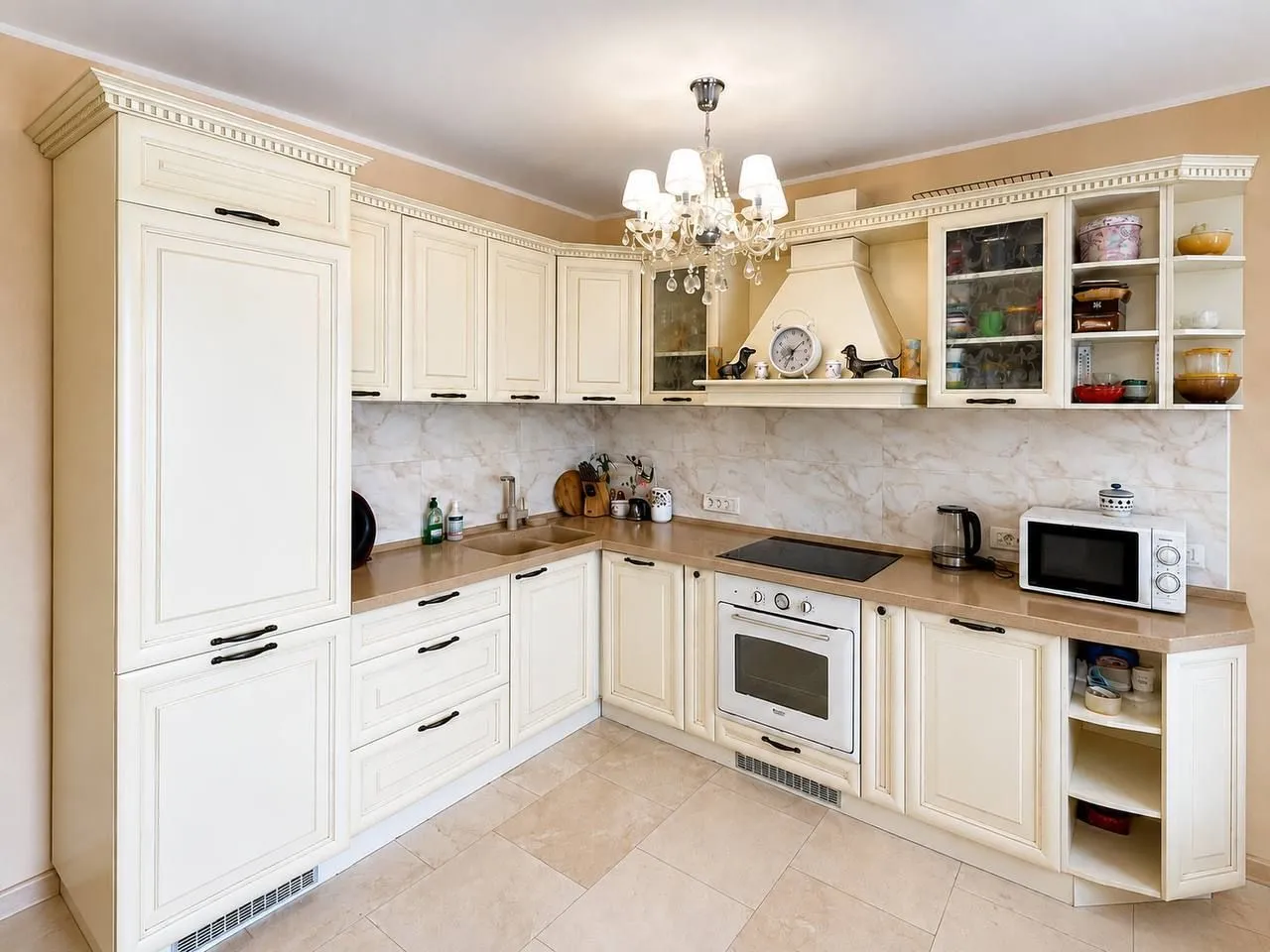 Kitchen equipped with beige cabinets and built-in appliances.