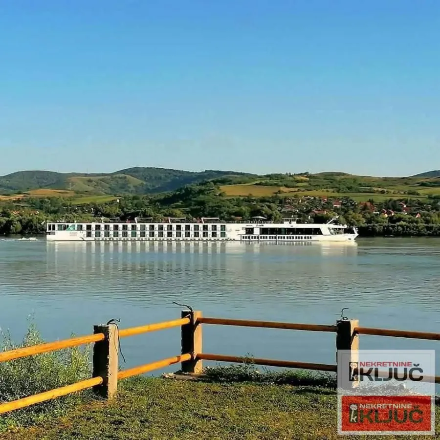 View of the river and a ship from the landscaped riverbank.