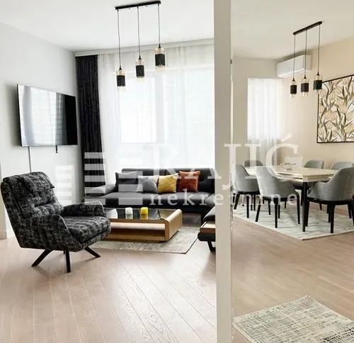 Modern living room with a sofa set and dining area.
