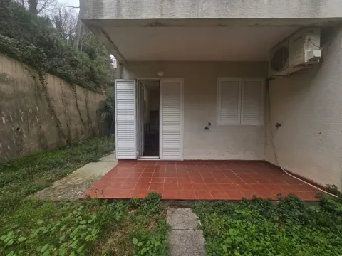Terrace and entrance to the ground floor of the house with tiled flooring and surrounding greenery. - image 11