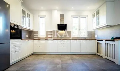 Modern kitchen with white cabinetry and built-in appliances. - image 10
