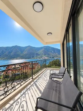 Covered balcony with seating furniture and a view of the sea and mountains. - image 2