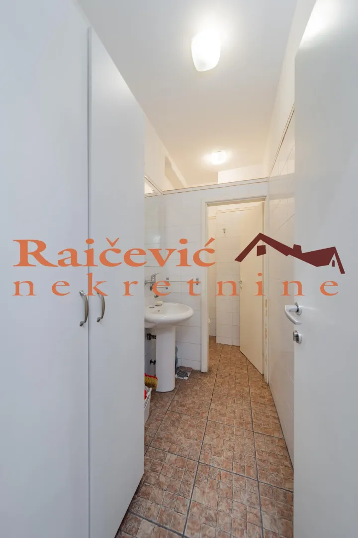 View of the bathroom with a washbasin and tiles.