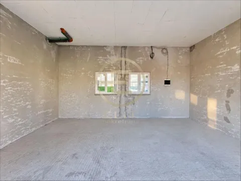 Empty room in rough construction phase with windows. - image 5