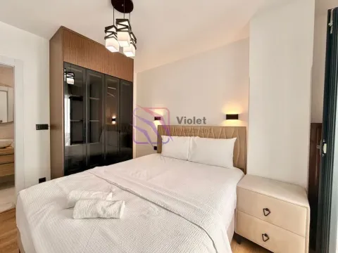 Furnished bedroom with a double bed, wardrobe, and a nightstand. - image 10