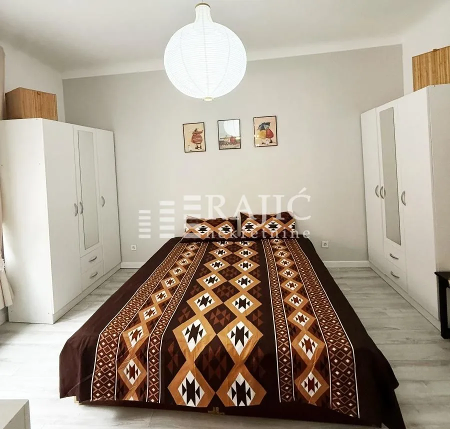 Bedroom with a double bed and white wardrobes.