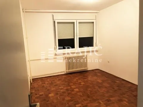 Empty room with parquet flooring and a window. - image 7