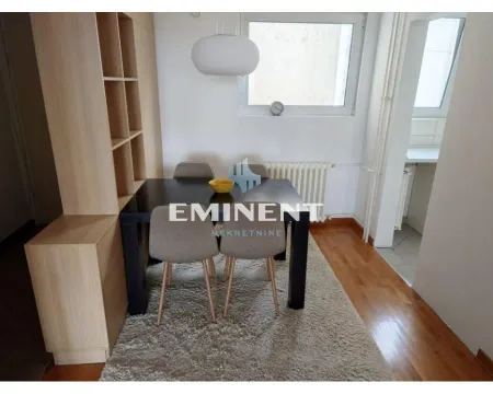 Dining area with a table, chairs, and a wooden partition shelf. - image 5