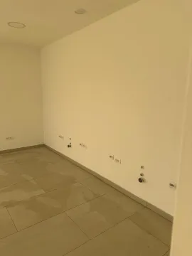 Empty room with ceramic floor tiles and wall connections. - image 3