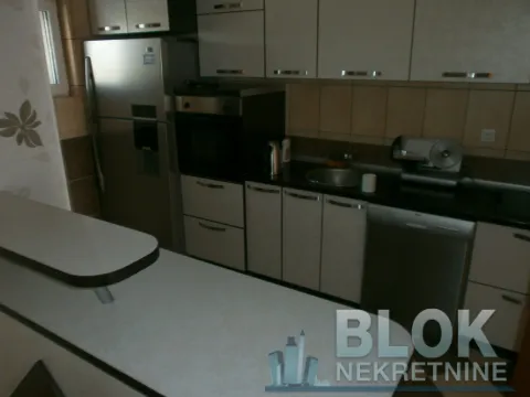 Kitchen with cabinetry, refrigerator and sink. - image 10