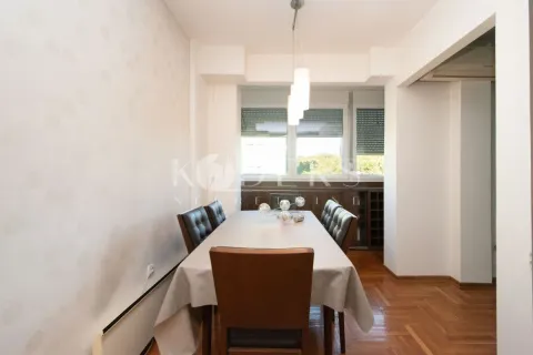 Dining room with a large table and chairs near the window. - image 3
