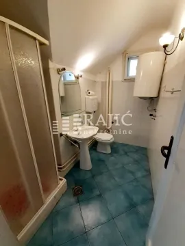 Small bathroom with blue floor tiles and a shower cabin. - image 8