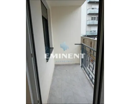 Empty balcony with metal railing and gray floor tiles. - image 2
