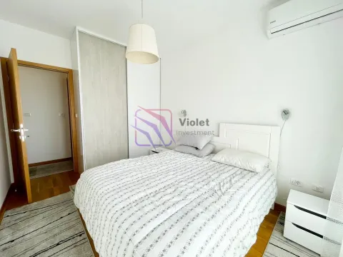 Furnished bedroom with a double bed, wardrobe, and air conditioning. - image 9