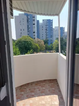 Smaller covered balcony with tiled flooring and a view of buildings. - image 12