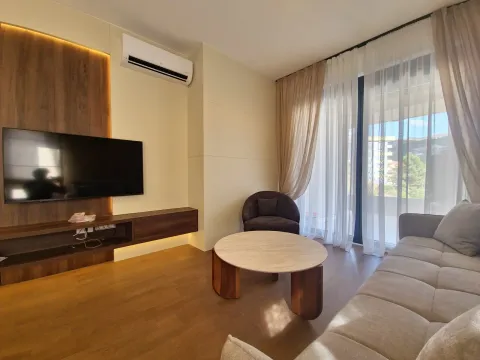 Living room with a sofa, TV, and access to the terrace. - image 3