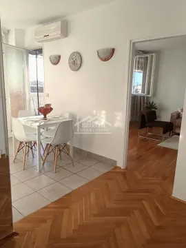 Dining area with a dining table and chairs, connected to the living room. - image 3