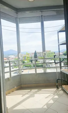 Enclosed balcony with a view of the city and surroundings. - image 8