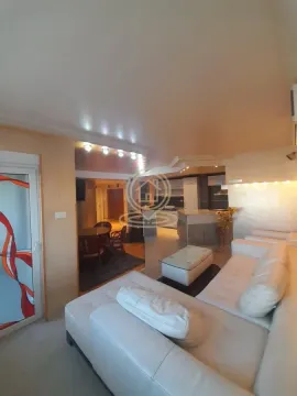 Living room with sofa and view of the dining area and kitchen. - image 9